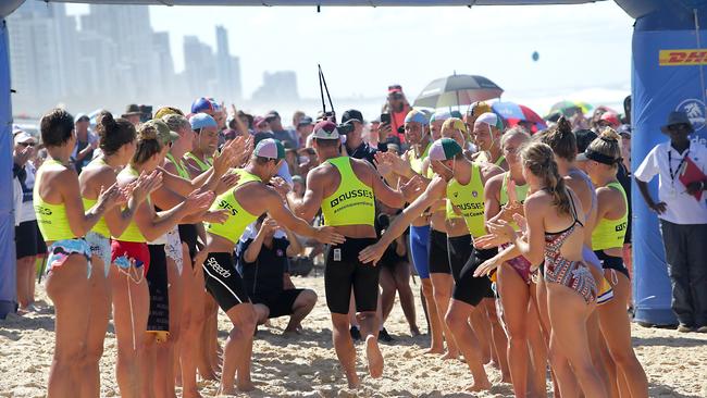 Fellow competitors form a guard of honour for Shannon Eckstein at the Australian Surf Life Saving Championships on the Gold Coast. Picture: HARVPIX