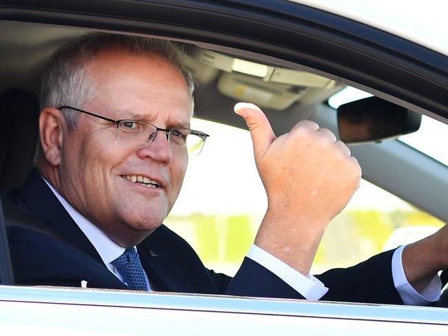 Australian Prime Minister Scott Morrison drives a hydrogen-powered car around a Toyota test track in Melbourne on November 9, 2021, after the government's launch of it's Future Fuels strategy. (Photo by William WEST / AFP)
