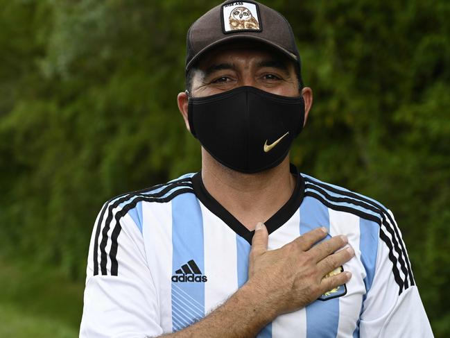 A fan gestures outside the gated community where football star Diego Maradona's home is located, in Benavidez, Buenos Aires. Picture: AFP