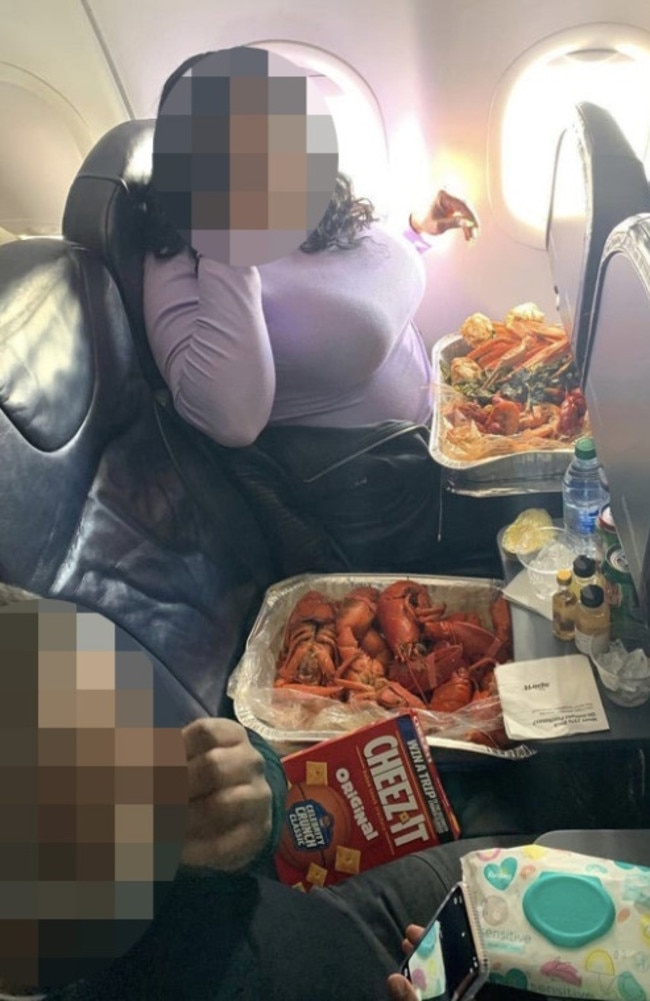 In the photo, the woman is seen sipping a drink with a large metal roasting tray in front of her filled with a seafood boil. Picture: Reddit