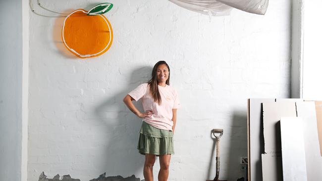 Yasmin Chung, owner of Sisterhood breakfast and brunch restaurant in Sandy Bay, with the iconic peach logo that is all that remains before it was gutted. Picture: NIKKI DAVIS-JONES