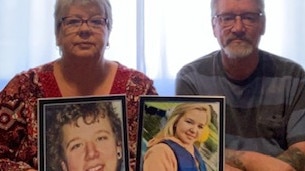 Lynette and Leigh Lyall with photos of their children, Troy and Shanae, who died in the same car crash. Picture: Supplied.