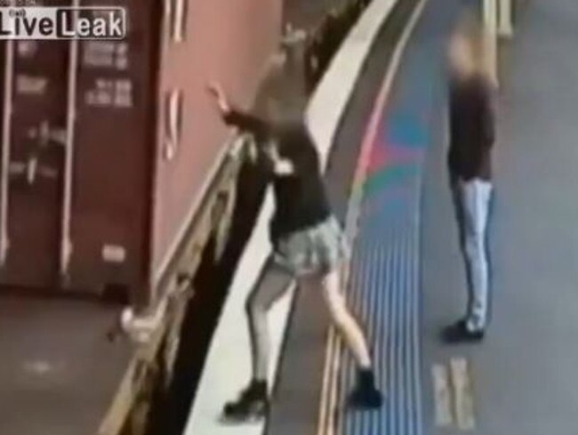 A young girl prepares to leap onto the empty carriage of a freight train. Source: www.liveleak.com