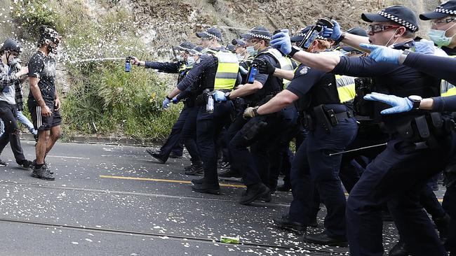 Police pepper spray anti-lockdown protesters in Kew. Picture: Alex Coppel