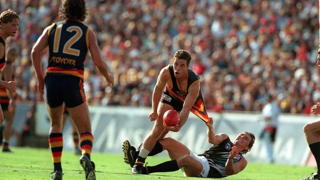 Brayden Lyle attempts to tackle Brett James as the Crow looks to handball.