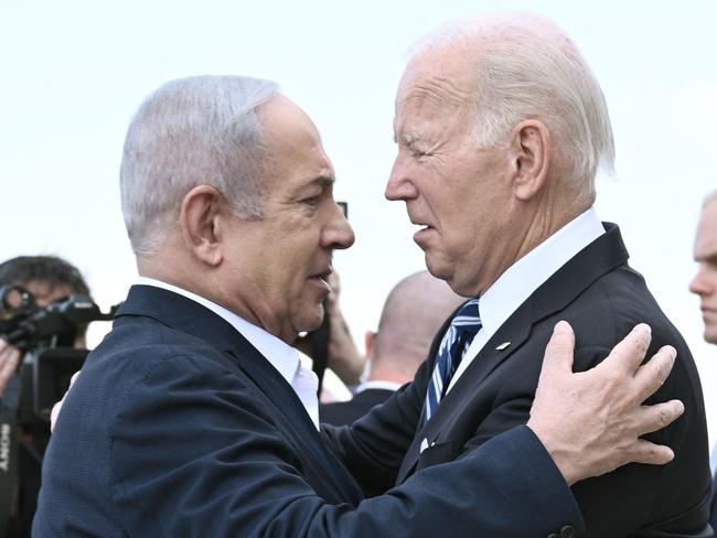 Israel Prime Minister Benjamin Netanyahu (L) greets US President Joe Biden upon his arrival at Tel Aviv's Ben Gurion airport on October 18, 2023, amid the ongoing battles between Israel and the Palestinian group Hamas. Biden landed in Israel on October 18, on a solidarity visit following Hamas attacks that have led to major Israeli reprisals. (Photo by Brendan SMIALOWSKI / AFP)