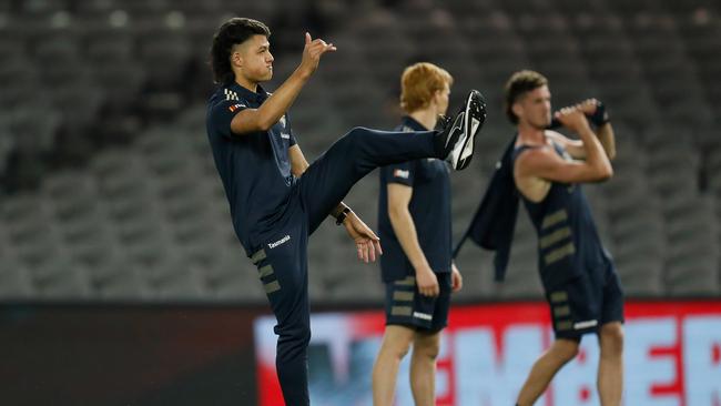 Connor Downie warms up before being the medical sub for Hawthorn.