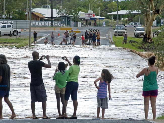 Locals enjoy the Todd River flow at the Ross Highway Causeway. PHOTO: Barry Skipsey