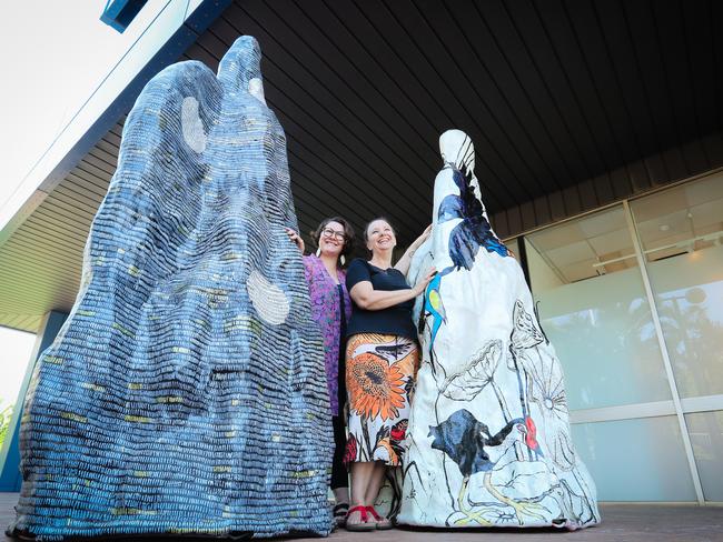 Local artists Alicia Scobie and Adrienne Wade with “re-imagined” termite mounds. Picture GLENN CAMPBELL