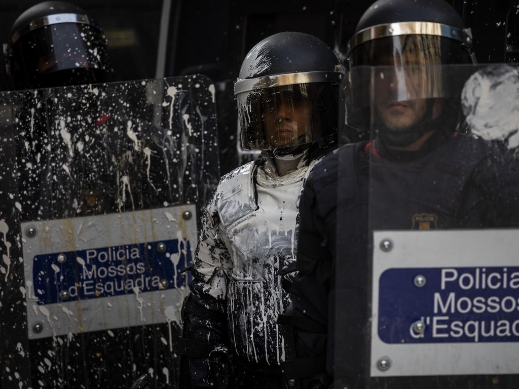 Catalan police were covered in paint thrown by pro-independence demonstrators. Picture: AP