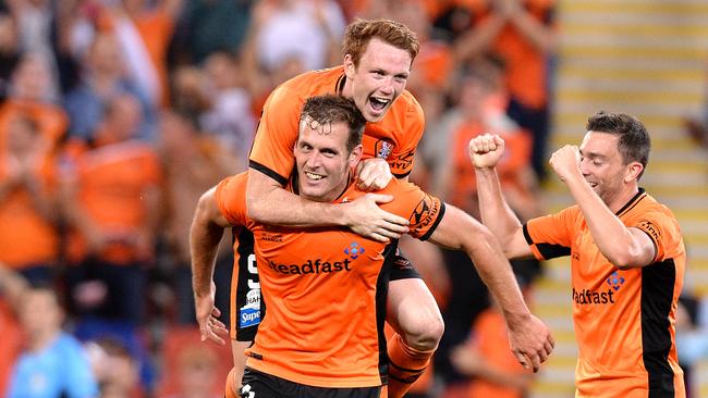 Luke DeVere of the Roar is congratulated by team mates after scoring a goal.