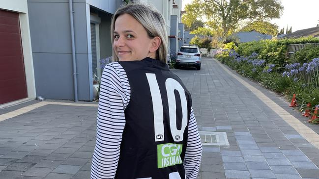 Kellie in her signed No. 10 Collingwood jumper. Picture: Supplied