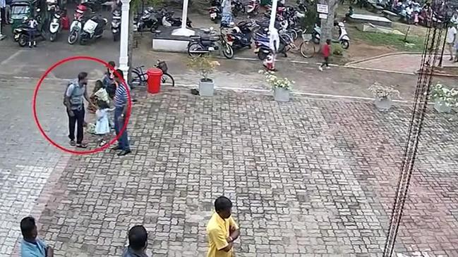 An attacker was pictured on CCTV patting a child before bombing St Sebastian’s Church.