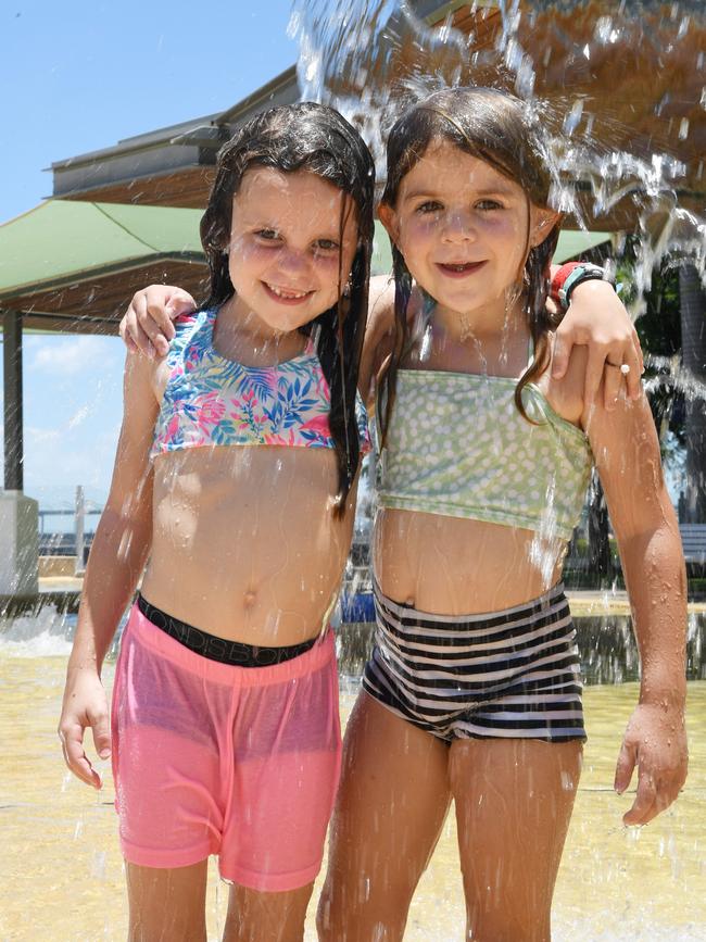 Bree Singleton and Erin Sibenaler cool down at the Darwin Waterfront as Darwin experiences heatwave conditions. Picture: Katrina Bridgeford