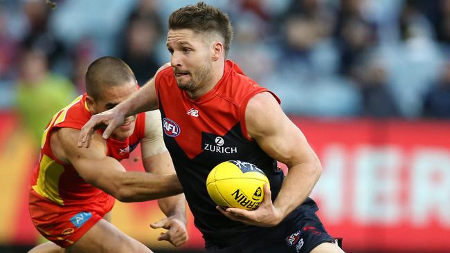 Jesse Hogan breaks the tackle of Jacob Dawson. Picture: Michael Klein