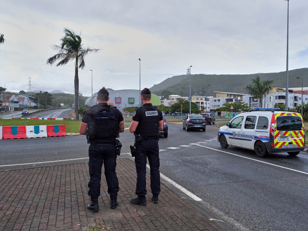 FILE - French gendarme patrol at a roundabout in Noumea, New Caledonia, Sunday Dec.12, 2021. At least two people were killed and three were seriously injured overnight in the French Pacific territory of New Caledonia, French officials there said Wednesday, May 15, 2024, as President Emmanuel Macron convened a meeting of top ministers to discuss the spiraling violence. (AP Photo/Clotilde Richalet, File)