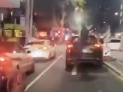 A person jumps on the car while its stopped in traffic. Picture: Instagram