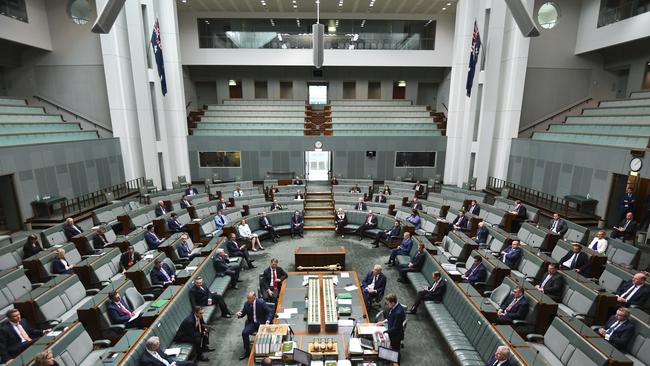 Federal MPs attend a sitting under rules of social distancing in the House of Representatives. Picture: AAP.