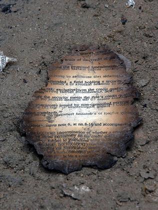 A charred document sits in the soot in the area near the destroyed World Trade Center. Picture: Stan Honda