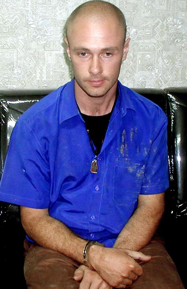 Jason Daron Mizner, an Australian man from Queensland sits with handcuffed while waiting for an interrogation at Chiang Mai police station in Chiang Mai province, Thailand, in 2006.