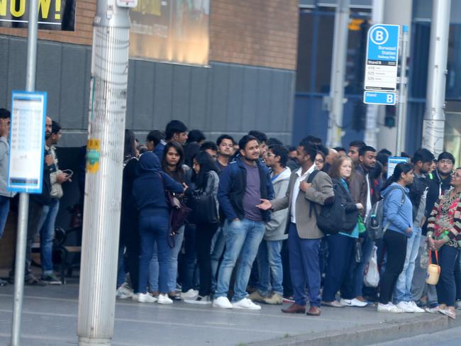 Commuters waiting in Burwood today. Picture: John Grainger