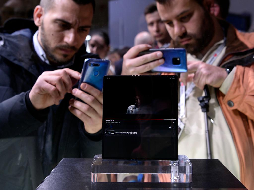 Visitors take images of Huawei's new foldable 5G smartphone HUAWEI Mate X at the Mobile World Congress. Picture: Josep LAGO / AFP