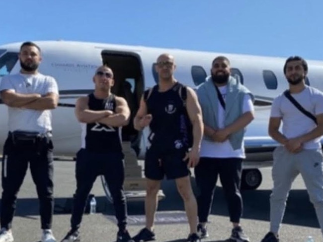 Associates of Comancheros boss Tarek Zahed (centre), include Salim Ascha (second from left), pose outside a private jet. Picture: Supplied