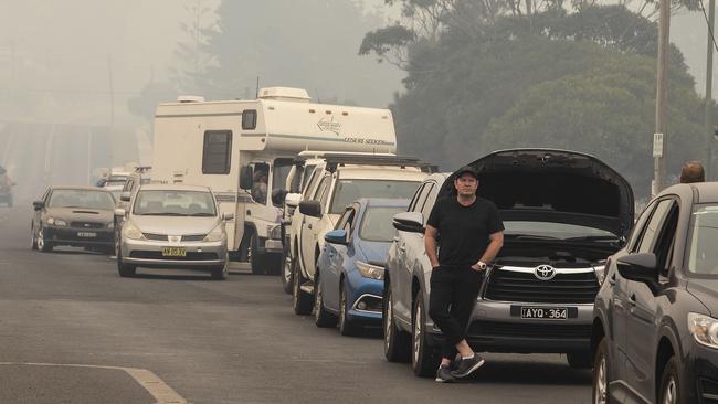 The queue as thousand evacuate the NSW south coast. Mark Hearn from Melbourne had been at his in-laws’ home at Bermagui since December 17 and his battery went flat while waiting to refill before evacuating. Picture Gary Ramage