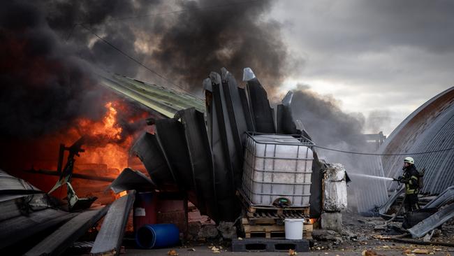 Firefighters try to extinguish a fire after a chemical warehouse was hit by Russian shelling on the eastern frontline near Kalynivka village, in Kyiv, Ukraine. Picture: Getty Images