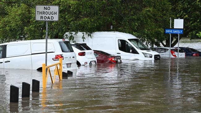 1/122024: Flash flooding in Hanlon Park , rapidly flooded around 10 cars, as police and fire and rescue  check the cars are empty, Stones Corner, Brisbane. pic: Lyndon Mechielsen/Courier Mail