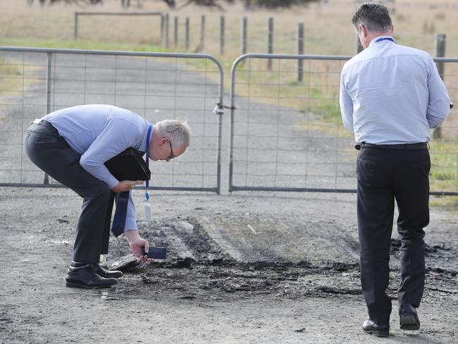 Detectives at the scene of the fire. Picture: David Crosling