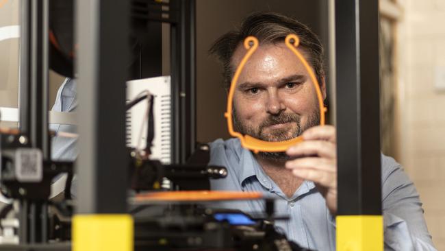 Canberra engineer and IT consultant Matthew Driver at home with his 3D printer. He is making personal protection equipment for health workers. Picture: Gary Ramage