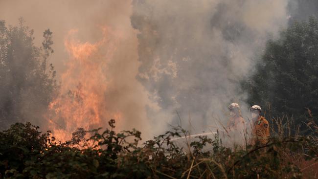 2019 January bushfires in Judbury from a bushfire that started at Riveaux Rd, South West. Tasmania Fire Service personnel put out a spot fire threatening a home on Donnelleys Rd, Geeveston. Picture: LUKE BOWDEN