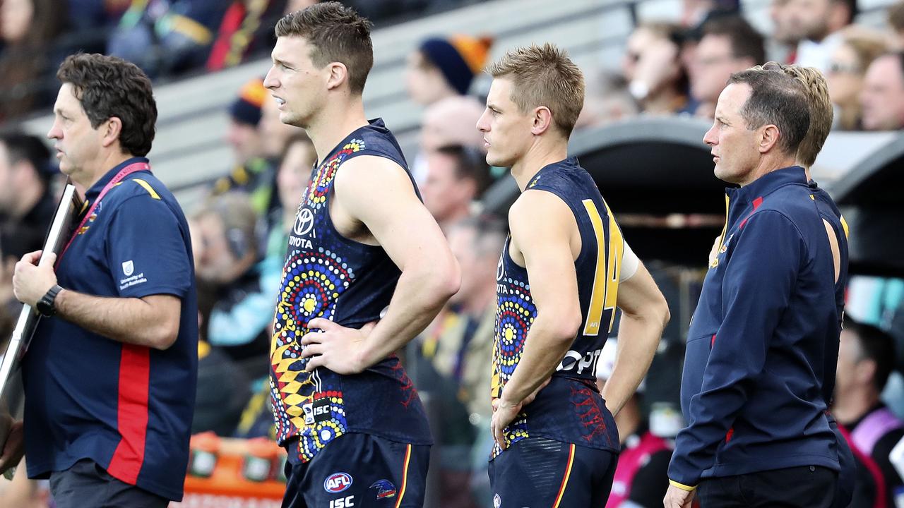 AFL - SHOWDOWN 47 - Adelaide Crows v Port Adelaide at the Adelaide Oval. Josh Jenkins with his knee heavily strapped with David McKay and Don Pyke Picture SARAH REED