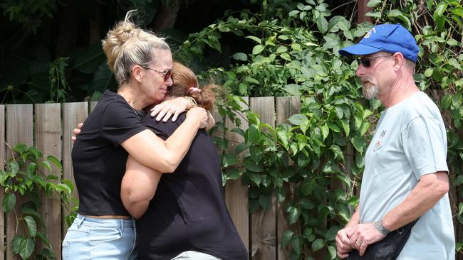 Allan Smillie's nieces Melissa Griffin and Kristy Marshall with husband Chris Griffin outside his home in Kingston. Picture: Liam Kidston