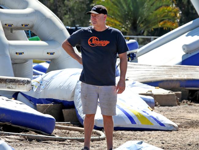 Jason Stone from Stoney Aqua Park at Telegraph Point with the remnants of his park inflatables after the floods. Nathan Edwards