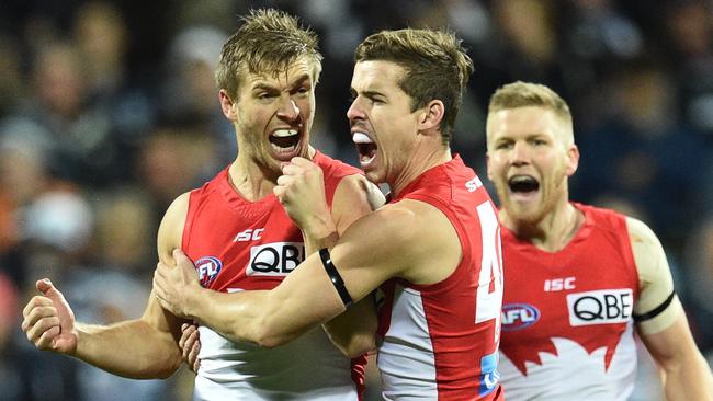 Kieren Jack of the Swans (left) reacts after he kicked the first goal during the Round 16 AFL match between the Geelong Cats and the Sydney Swans at Simonds Stadium in Geelong, Friday, July 8, 2016. (AAP Image/Julian Smith) NO ARCHIVING, EDITORIAL USE ONLY