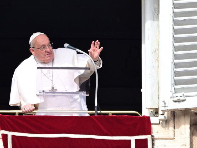 Pope Francis waves to the crowd from the window of the apostolic palace overlooking St. Peter's square during the Angelus prayer in The Vatican on February 2, 2025. (Photo by Tiziana FABI / AFP)