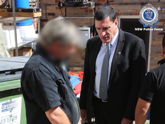 The 43-year-old Scotland Island man speaks with a detective from Strike Force Trawler outside a business in Collaroy Plateau. Picture: NSW Police