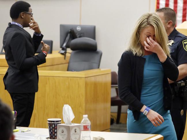 Former Dallas Police Officer Amber Guyger walks back to her desk after hugging victim Botham Jean's younger brother Brandt Jean following her sentencing. Picture: AP