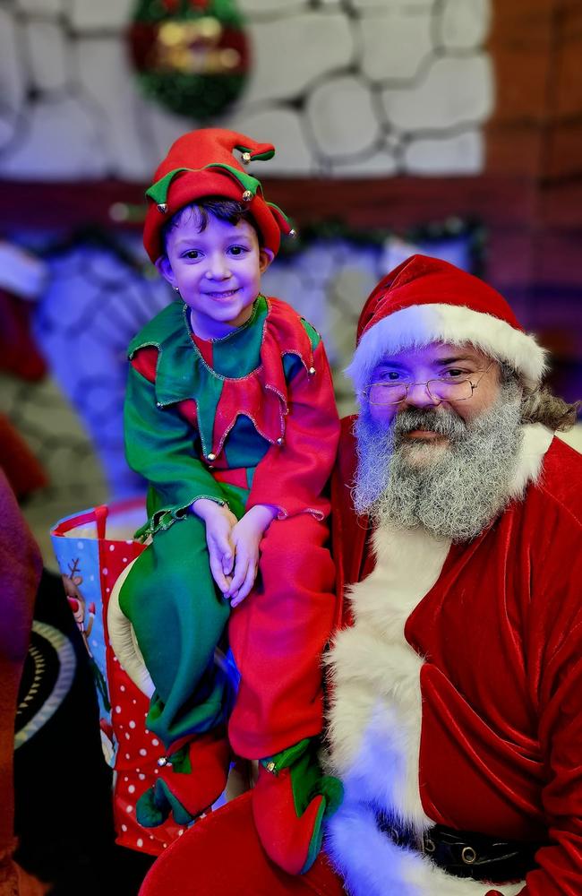 FCC santa photos 2023: Santa (Damien Symes) and his elf (Xander Symes): Fraser Coast Disability dinner where Flame Studios Hervey Bay performed (2023). Sent in by Flame Studios Hervey Bay.