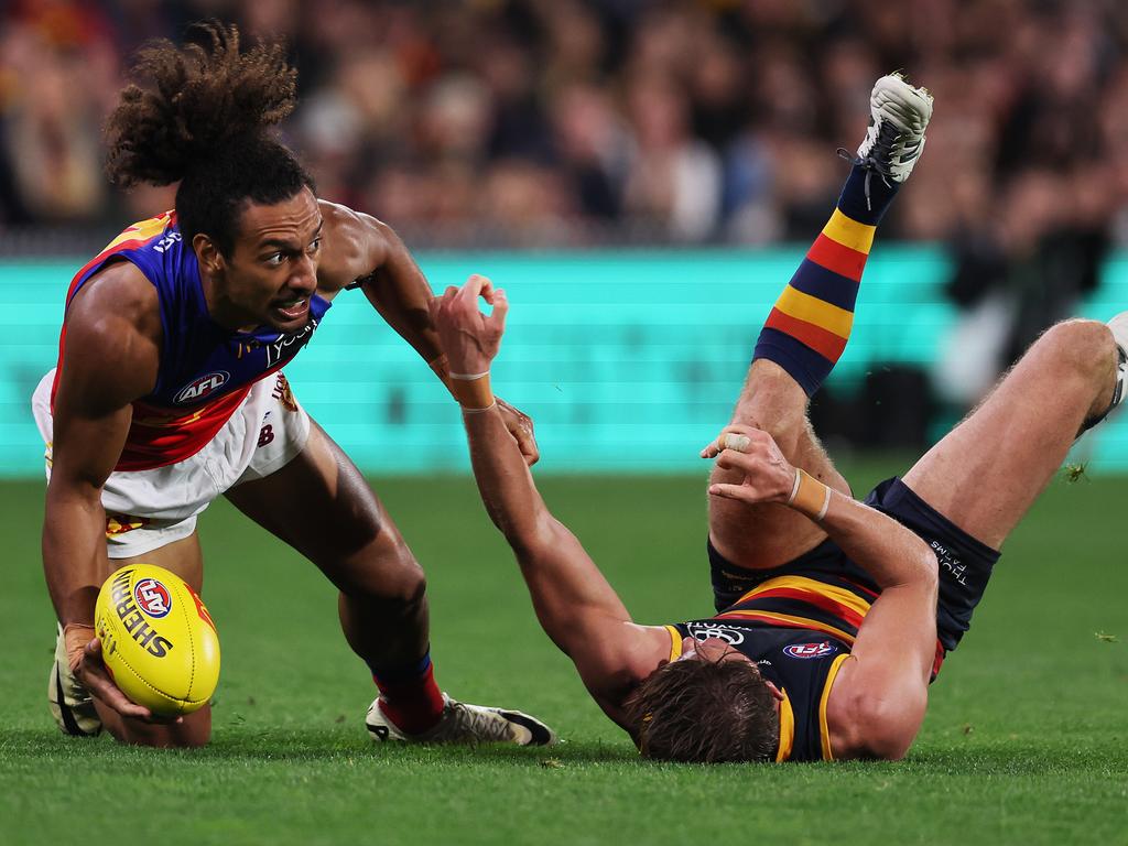 ADELAIDE, AUSTRALIA - MAY 02: Bruce Reville of the Lions is tackled by Matt Crouch of the Crows during the 2024 AFL Round 08 match between the Adelaide Crows and the Port Adelaide Power at Adelaide Oval on May 02, 2024 in Adelaide, Australia. (Photo by James Elsby/AFL Photos via Getty Images)