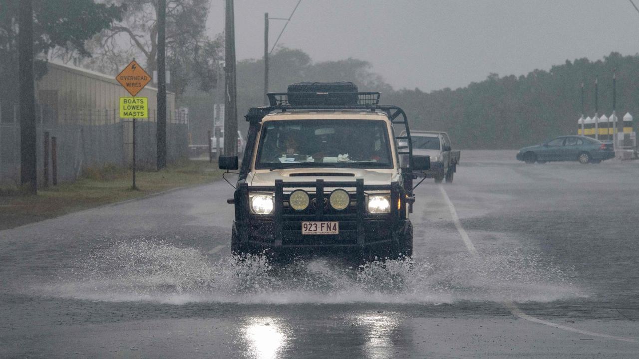 A motorist drives through floodwate. Picture: Brian Cassey