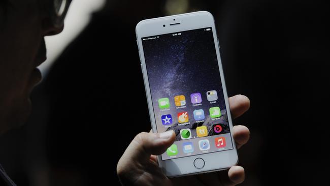 An attendee demonstrates the new Apple Inc. iPhone 6 Plus after a product announcement at Flint Center in Cupertino, California, U.S., on Tuesday, Sept. 9, 2014. Apple Inc. unveiled redesigned iPhones with bigger screens, overhauling its top-selling product in an event that gives the clearest sign yet of the company's product direction under Chief Executive Officer Tim Cook. Photographer: David Paul Morris/Bloomberg