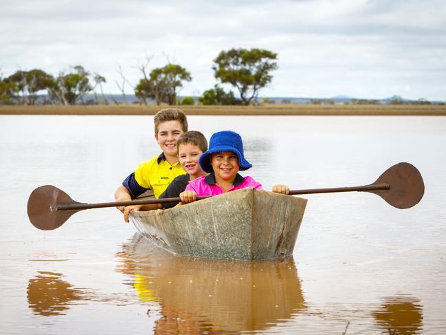 Fourth Generation Boongala children, Denzel, Evan and Jaeden paddle the canoe their Grandfather Barry Koch, built to paddle on the same flood filled low laying land in the floods of 1968. Picture: Emma Brasier