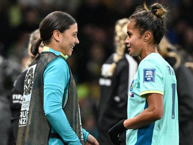 Australia's forward #11 Mary Fowler (R) speaks with Australia's forward #20 Sam Kerr (L) during the Australia and New Zealand 2023 Women's World Cup Group B football match between Canada and Australia at Melbourne Rectangular Stadium, also known as AAMI Park, in Melbourne on July 31, 2023. (Photo by WILLIAM WEST / AFP)