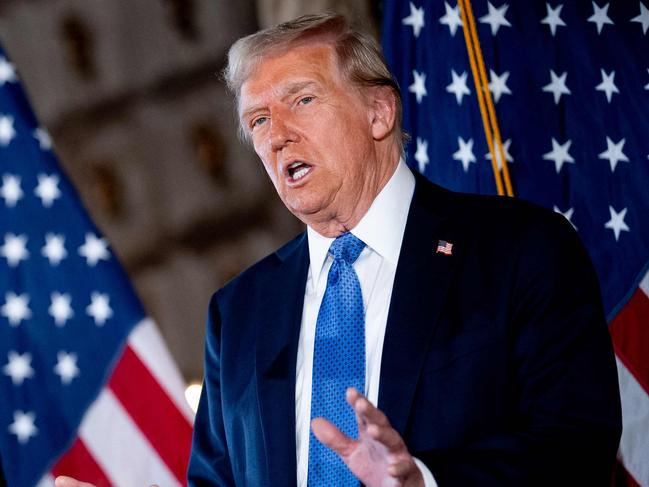 PALM BEACH, FLORIDA - DECEMBER 16: U.S. President-elect Donald Trump, accompanied by Trump's choice for Secretary of Commerce, Cantor Fitzgerald Chairman and CEO Howard Lutnick, speaks at a news conference at Trump's Mar-a-Lago resort on December 16, 2024 in Palm Beach, Florida. In a news conference that went over an hour, Trump announced that SoftBank will invest over $100 billion in projects in the United States including 100,000 artificial intelligence related jobs and then took questions on Syria, Israel, Ukraine, the economy, cabinet picks, and many other topics.   Andrew Harnik/Getty Images/AFP (Photo by Andrew Harnik / GETTY IMAGES NORTH AMERICA / Getty Images via AFP)