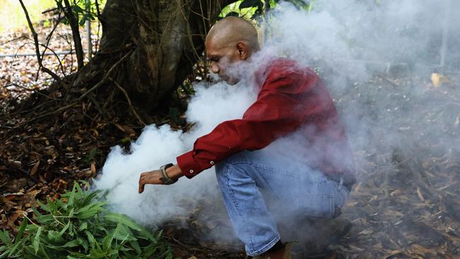 Djabugay Nation member Alfred Gray officially begins the sod turning ceremony with a smoking ceremony. Picture: Brendan Radke