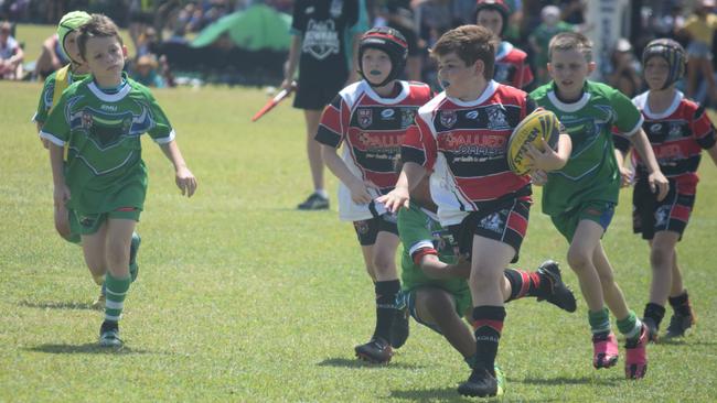 Bowen Seagulls Red's Isaiah Palmer (with the ball) is ahead of the pack in the match against Proserpine Whitsunday Blue at the Paul Bowman Challenge for under 9s rugby league players at Proserpine.