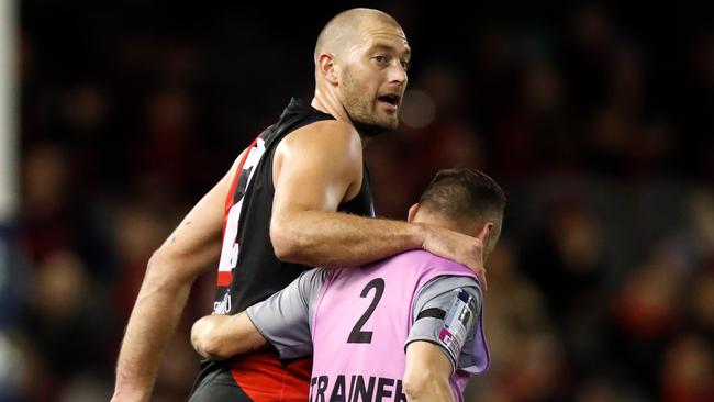 Tom Bellchambers is assisted off the field. Picture: Getty Images